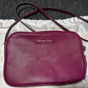 Michael Kors Crossbody.  Scratch on right corner and color transfer on back.